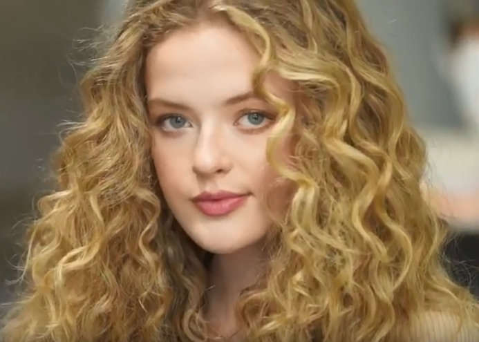 Model with curly hair after TO112 hair tutorial is complete