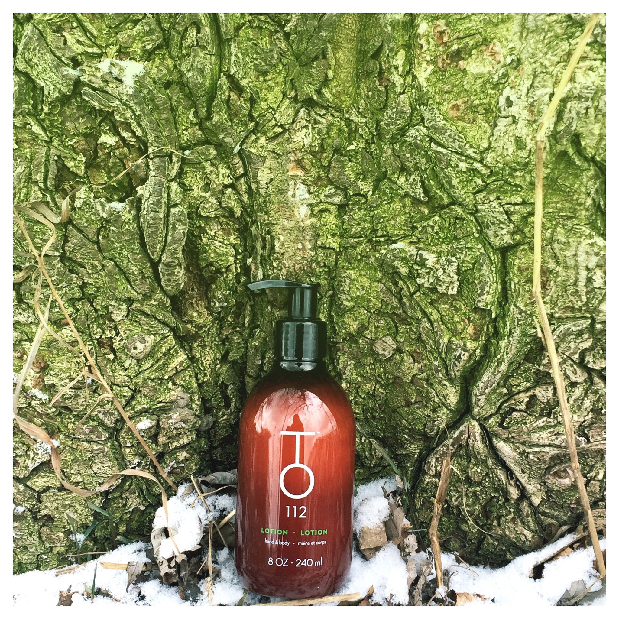 to112 hair serum on forest moss tree in background