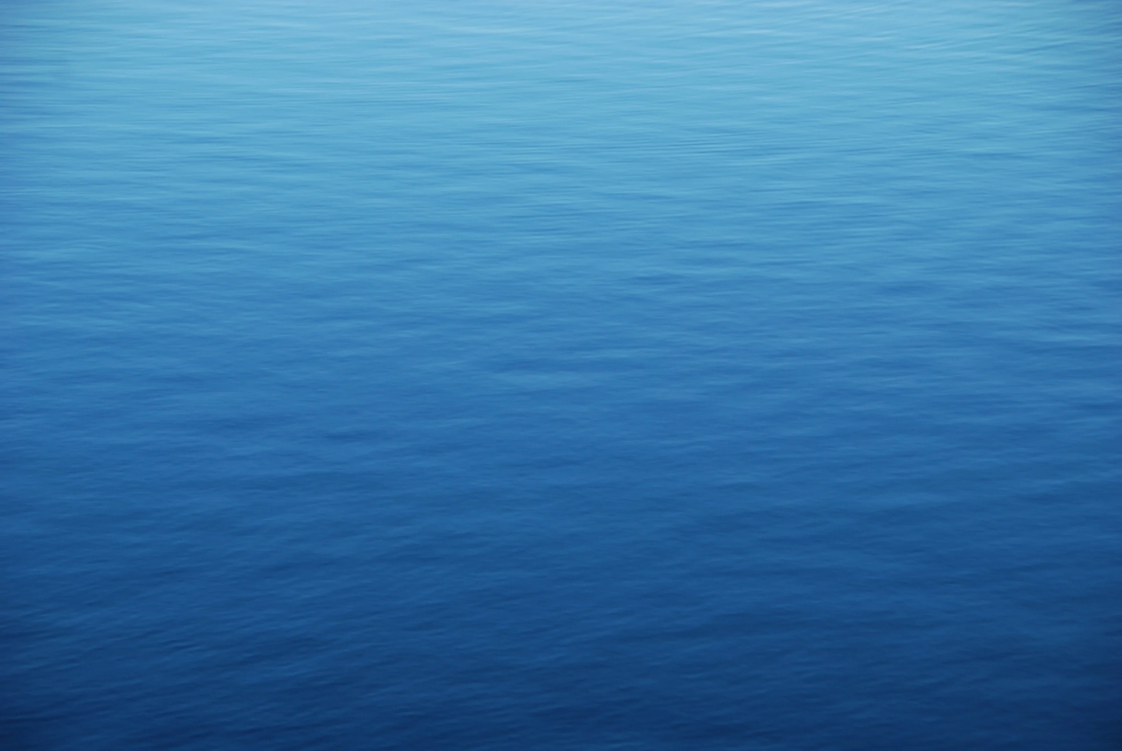 calm blue expanse of ocean water with soft rippling waves