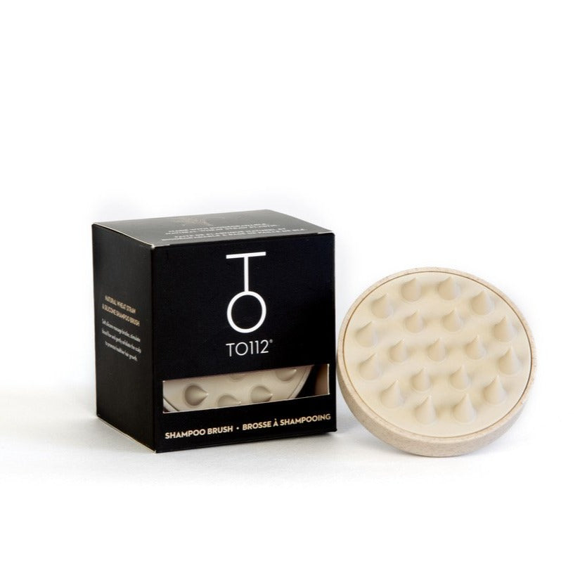 Stock image of To112 Natural Wheat Straw & Silicone Shampoo Brush beside box on a white backdrop